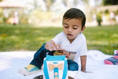 Young woman using mobile phone at park