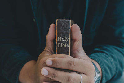 Close-up of hand holding text