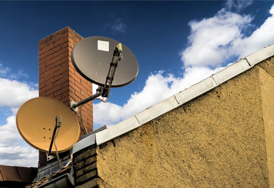 Low angle view of antenna on terrace against sky