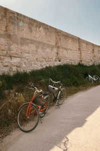 Bicycle parked against wall