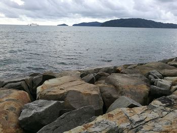 Scenic view of sea and mountains against sky