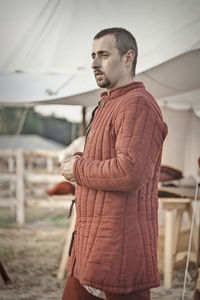 Man looking away while standing outdoors