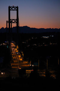 Illuminated city against sky at night