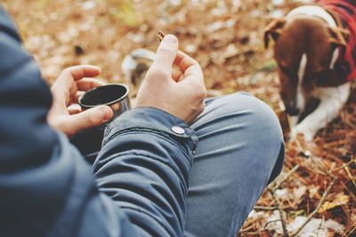 Midsection of man using mobile phone