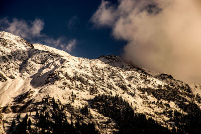 Scenic view of mountains against cloudy sky