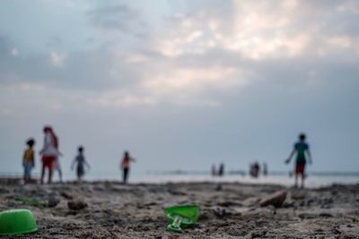 People on beach against sky