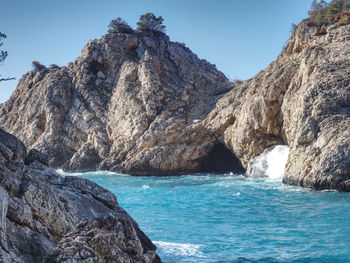 Peguera village, mallorca island. sea wave still breaks on beach rocks landscape. sea waves crash 