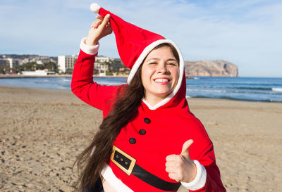 Portrait of smiling young woman on beach