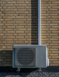 Air conditioner on brickwall in sunshine, denmark