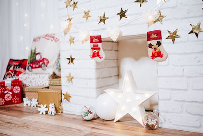 Christmas decoration at home. chimney, gifts, tree, noel, cushions on beautiful indoor white studio.