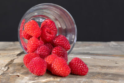 Close-up of raspberries in a glass on table