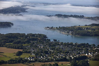 High angle view of sea and trees against sky