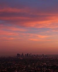 Aerial view of cityscape against romantic sky during sunset