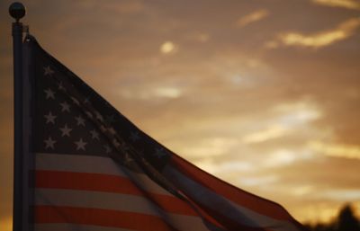 Low angle view of flag against sky during sunset