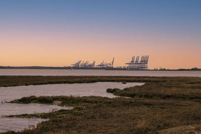 Scenic view of sea against clear sky during sunset