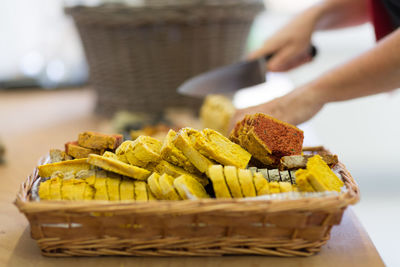 Close-up of man preparing food in basket