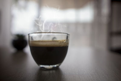 Close-up of coffee in glass on table