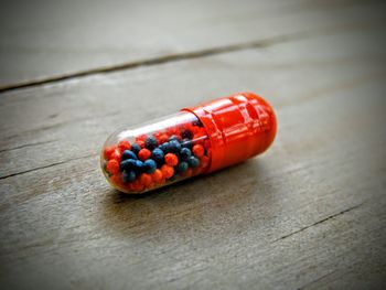 Close-up of pill on wooden table