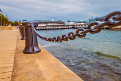 Close-up of chain against sea