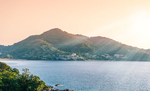 Scenic view of lake and mountains against clear sky