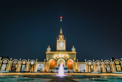 Illuminated building against sky at night