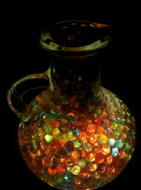 Close-up of glass jar against black background