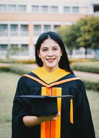 Portrait of smiling woman standing outdoors