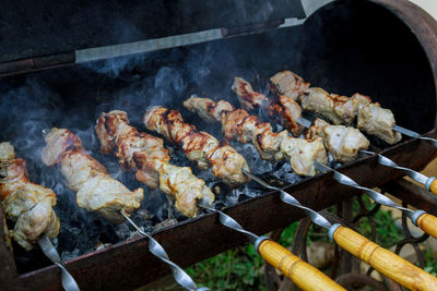 High angle view of meat on barbecue grill