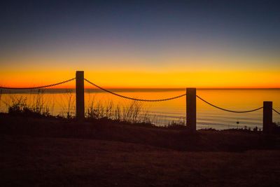 Silhouette of suspension bridge at sunset