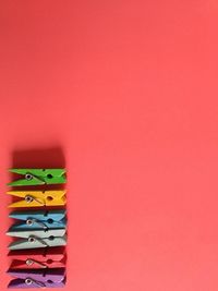 Close-up of multi colored pencils against red background