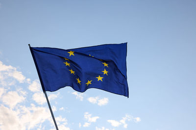 Low angle view of flag against clear blue sky