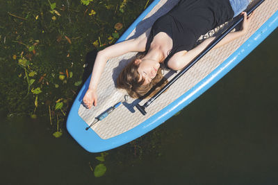 High angle view of woman lying on swimming pool