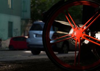 Close-up of red bicycle on road in city