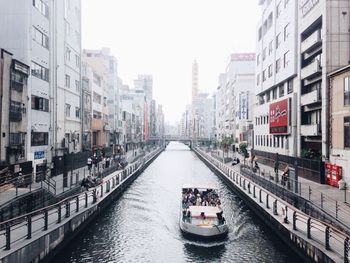 Boats in canal along buildings