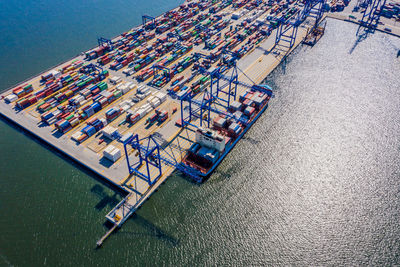 Container ship export and import business and logistics shipping cargo to harbor by crane. aerial 
