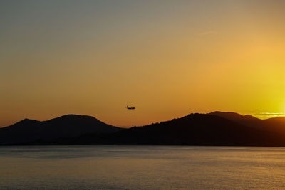 Scenic view of silhouette mountains against sky during sunset