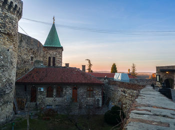 Old building in city against sky during sunset