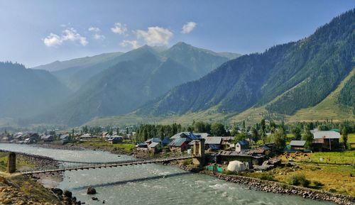 Scenic view of buildings and mountains against sky