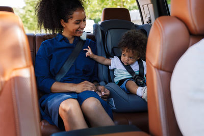 Side view of woman sitting in car