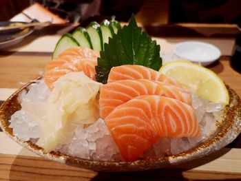 Close-up of sashimi with ice in plate on table