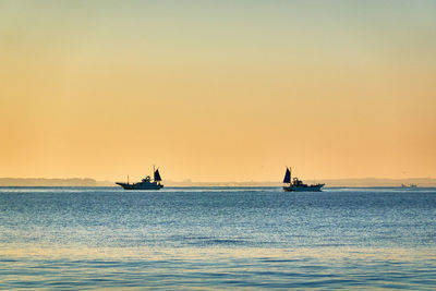 Scenic view of sea against clear sky during sunrise