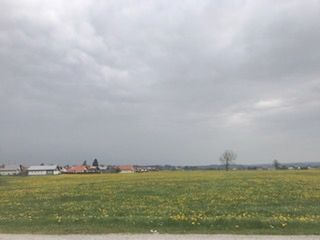 Scenic view of field against storm clouds