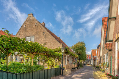 Street amidst buildings in town against sky