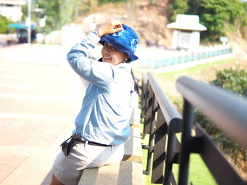 Rear view of boy standing in park