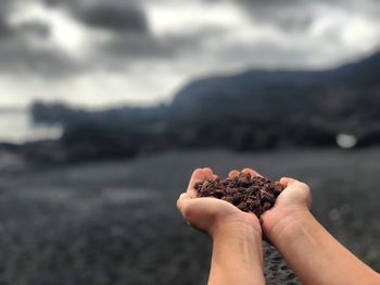 Close-up of hand holding mud