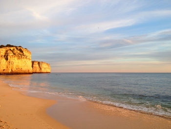 View of beach against cloudy sky