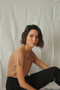 Portrait of young woman on white background