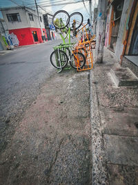 Bicycle parked on footpath by building