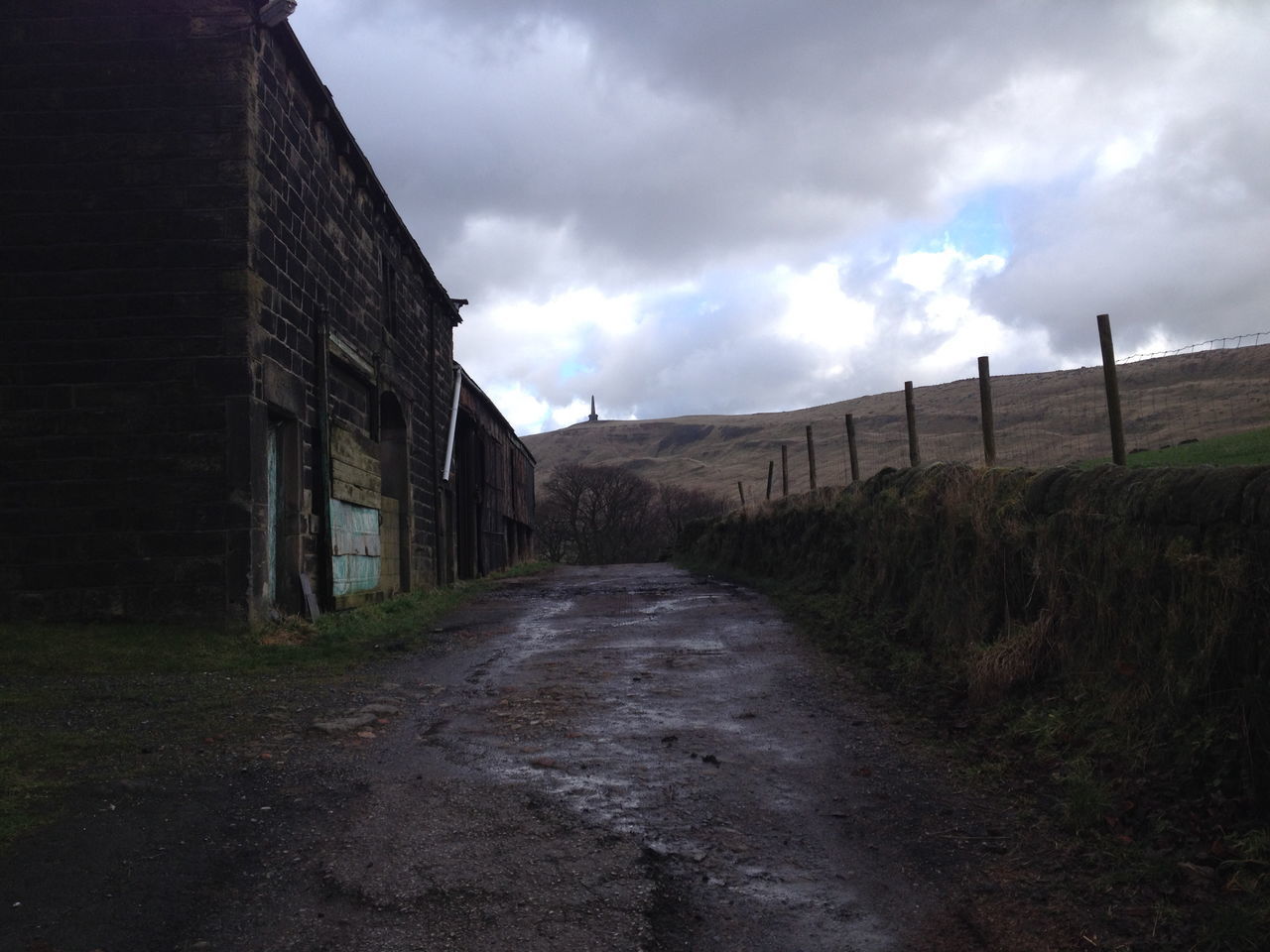 ROAD BY BUILDING AGAINST SKY