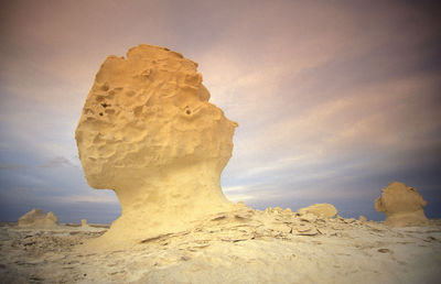 Scenic view of desert against sky during sunset